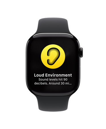 Pohled zepředu na Apple Watch Series 10 s bílým sportovním řemínkem, na displeji se zobrazuje ikona upozornění na vysoký hluk s textem Hlučné prostředí, úroveň hluku dosáhla 90 dB.