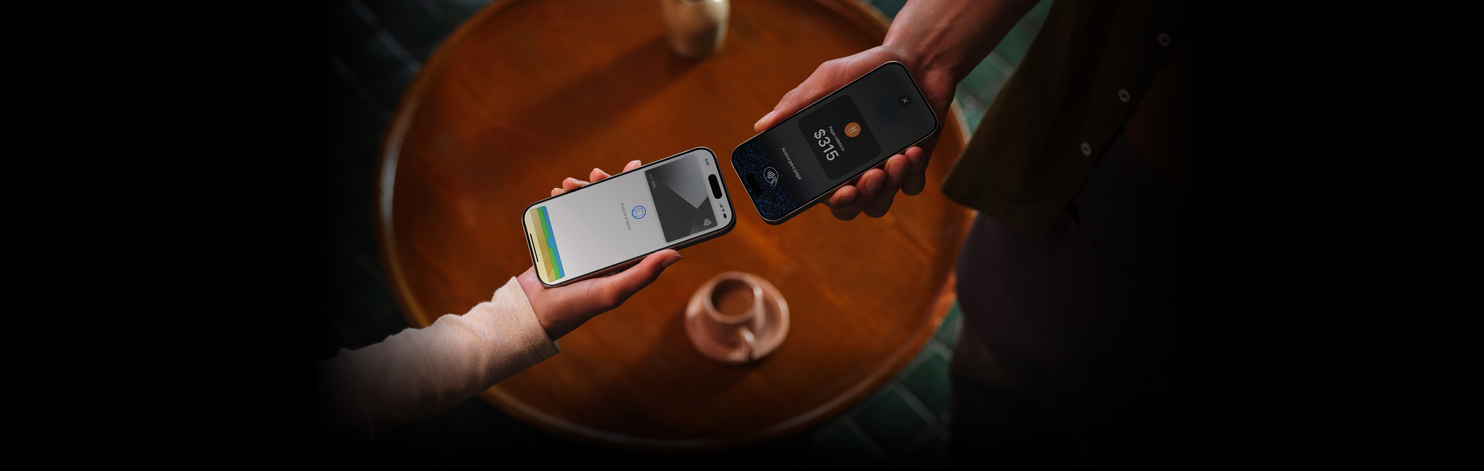 Imagen de dos personas que acercan sus dispositivos iPhone para realizar una transacción.