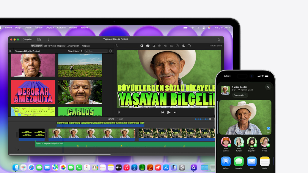 MacBook Neo, gümüş rengi, ekranda Yaşayan Bilgelik Projesi başlıklı iMovie penceresi yer alıyor, yanındaki iPhone’un ekranında ise iMovie penceresindeki kişilerden birinin videosu gösteriliyor, videonun altında aralarında AirDrop’un da bulunduğu paylaşım seçenekleri listeleniyor