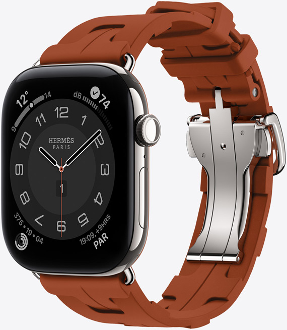 Apple Watch Hermès Series 12, Circulaire analogue watch face, (hour, minute and second hands, complications: Weather, Noise, Activity rings, and Paris time), titanium case, silver colour, right side exterior, Digital Crown, side button, paired with Kilim Single Tour strap, cuivre colour (brown), moulded rubber material, geometric interlocking design, silver-coloured metal clasp
