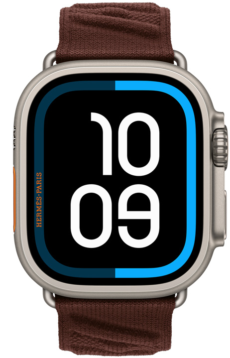 Apple Watch Hermès Ultra 4, carátula Maritime digital, caja de titanio, color natural, parte lateral derecha, Digital Crown, botón lateral en relieve, con la correa En Mer, color Bordeaux (café oscuro), material tejido texturizado