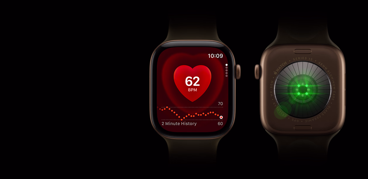Two Apple Watch Series 12 devices, aluminum case, dark bronze colour with olive Sport Band, one with Heart Rate app, the other showing the Health Sensing System on the back of the watch, with glowing green LED lights