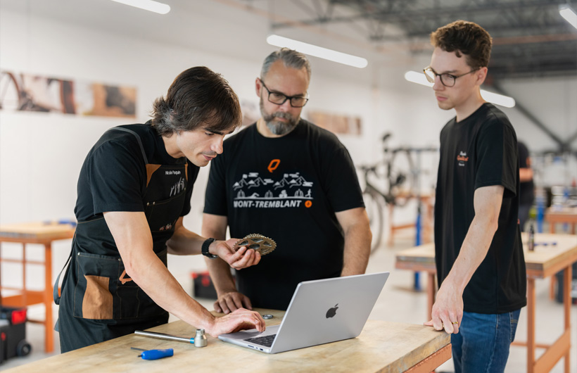 Nicolas Paquin, a Bicycles Quilicot trainer, uses MacBook Pro to access materials for the company’s free bicycle mechanic certification program.