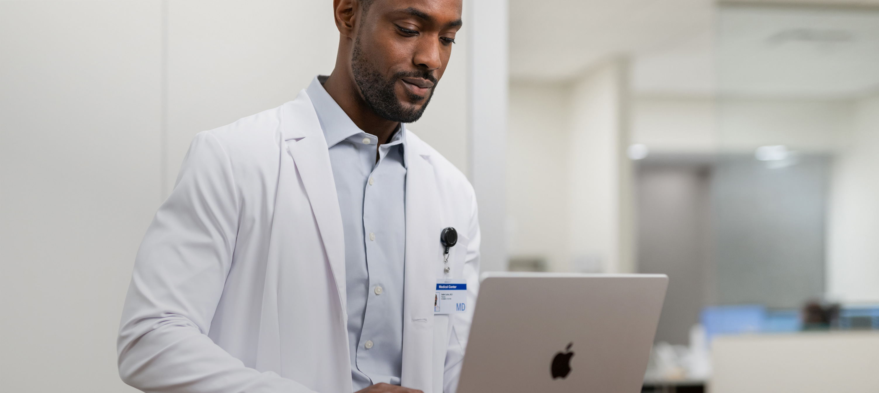 A physician working on his MacBook Pro in the hospital.